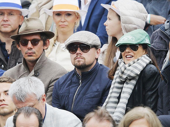 US actor Leonardo DiCaprio (centre) watches the men's singles final match between Rafael Nadal of Spain and compatriot David Ferrer at the French Open on Sunday
