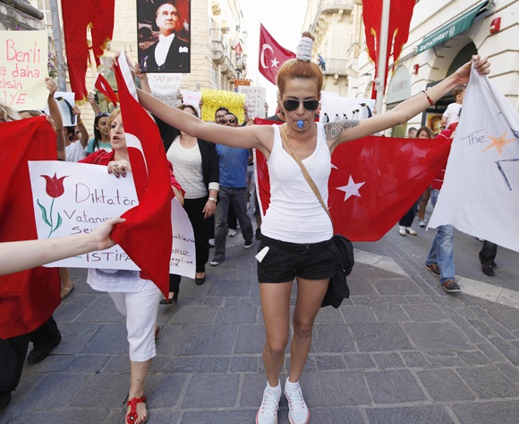 Members of the Turkish community living in Malta take part in a peaceful protest in solidarity with their compatriots in Turkey