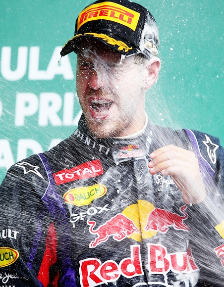 Sebastian Vettel of Red Bull celebrates on the podium after winning the Canadian Formula One Grand Prix