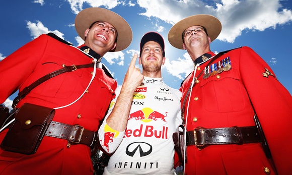 Sebastian Vettel celebrates with two Canadian Mounties