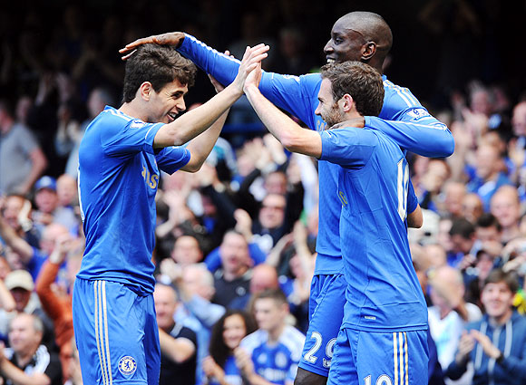 Chelsea's Juan Mata celebrates with teammates Oscar and Demba Ba 
