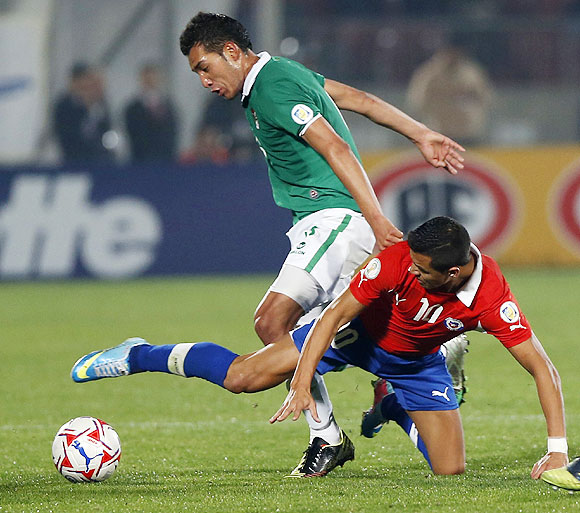  Chile's Alexis Sanchez (right) and Bolivia's Walter Veizaga vie for possession during their 2014 World Cup qualifier in Santiago on Tuesday