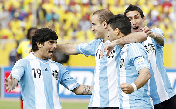 Argentina's Sergio Aguero (2nd from right) celebrates with teammates Ever Banega (left), Rodrigo Palacio and Angel Di Maria celebrate (right) after scoring against Ecuador on Tuesday