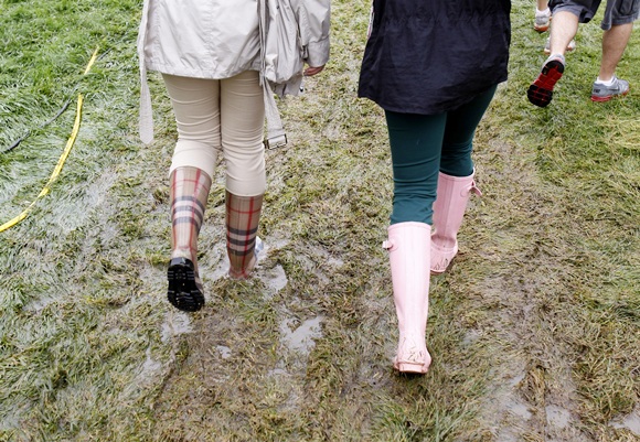 Spectators walk on a flooded pathway along a fairway duringUS   Open golf championship