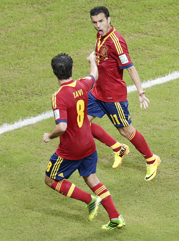 Spain's Pedro (right) celebrates teammate Xavi after scoring against Uruguay during their Confederations Cup Group B match at the Arena Pernambuco in Recife, Brazil on Sunday