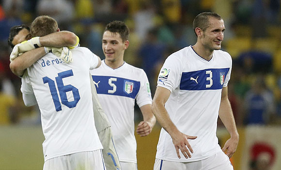 Italy's players Gianluigi Buffon (back, obscured), Daniele De Rossi, Mattia De Sciglio and Giorgio Chiellinicelebrate at the end of their Confederations Cup Group A match against Mexico at the Estadio Maracana in Rio de Janeiro on Sunday