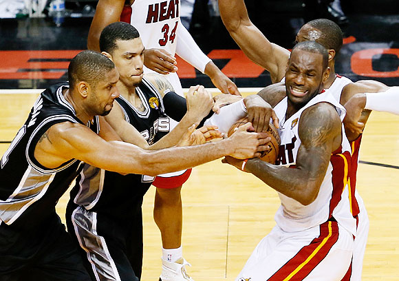 Tim Duncan and Danny Green of the San Antonio Spurs battle for the ball with LeBron James and Dwyane Wade of the Miami Heat in overtime during Game Six of the 2013 NBA Finals at AmericanAirlines Arena in Miami, Florida on Tuesday