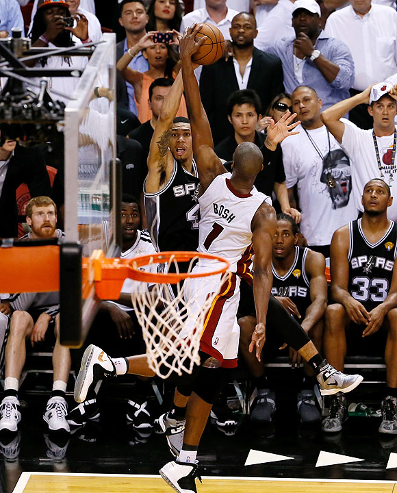 Chris Bosh of the Miami Heat blocks the last second three-point attempt by Danny Green of the San Antonio Spurs