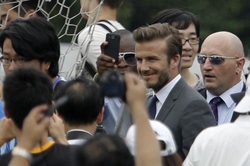David Beckham arrives at Tongji University, in Shanghai, surrounded by his fans
