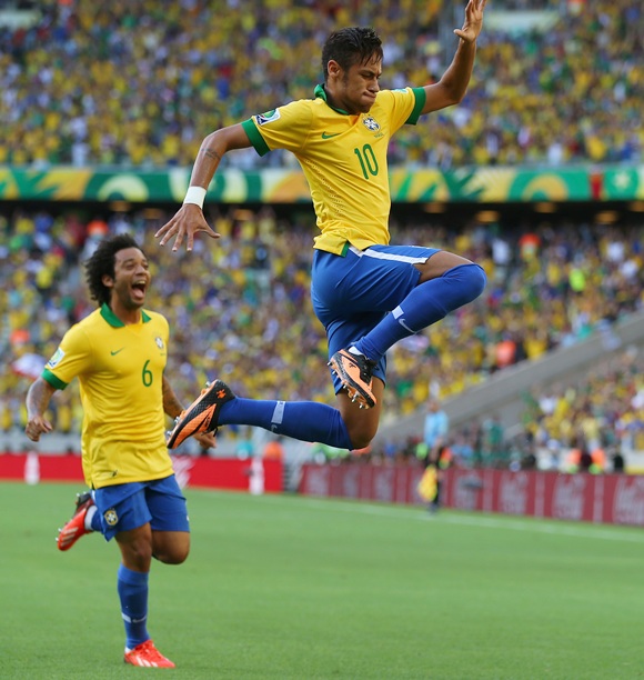 Neymar of Brazil celebrates scoring the opening goal with teammate Marcelo