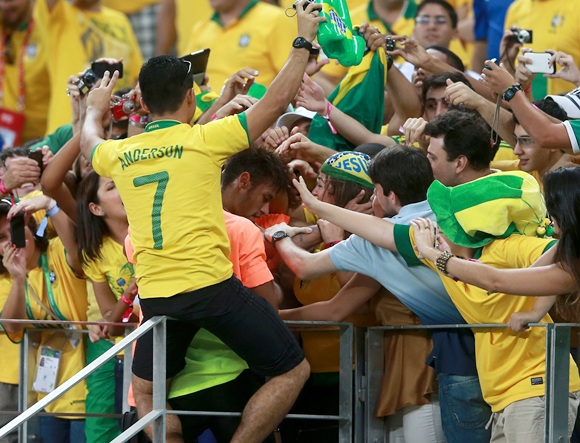 Neymar of Brazil celebrates with fans