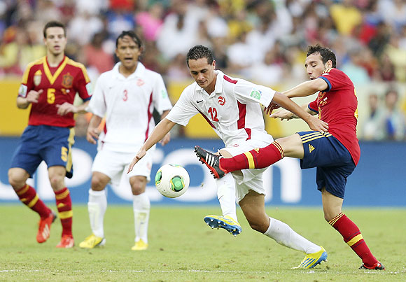 Tahiti's Edson Lemaire (2nd from right) fights for the ball with Spain's Santi Cazorla (right) during their Confederations Cup Group B match at the Estadio Maracana in Rio de Janeiro on Thursday