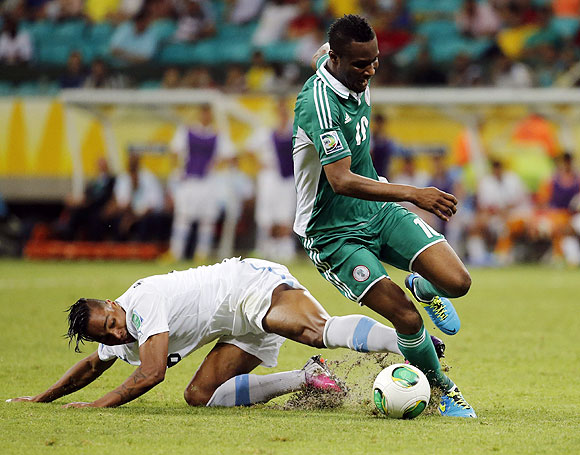 Uruguay's Alvaro Pereira (left) fights for the ball with Nigeria's John Obi Mikel during their Confederations Cup Group B match at the Arena Fonte Nova in Salvador on Thursday