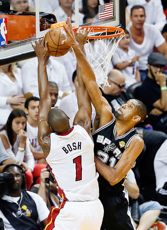 Chris Bosh #1 of the Miami Heat goes up for a dunk over Tim Duncan #21 of the San Antonio Spurs in the first half during Game Seven of the 2013 NBA Finals on Thursday