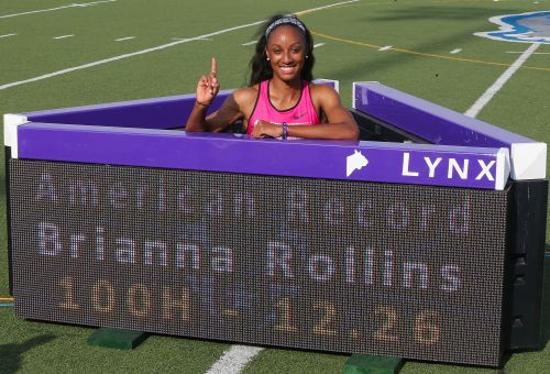 Brianna Rollins poses with the sign board after setting a new American Record of 12.26 seconds in the Women's 100 Meter Hurdles final on day three of the 2013 USA Outdoor Track & Field Championships at Drake Stadium
