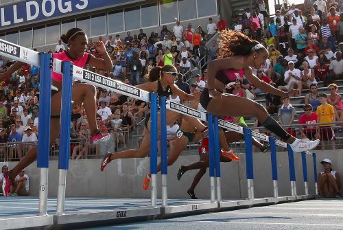 Brianna Rollins (R) clears a hurrdle en route to winning the Women's 100 Meter Hurdles final on day three of the 2013 USA Outdoor Track & Field Championships at Drake Stadium