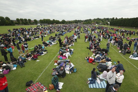 Fans queue for entry into the grounds on day one of the Wimbledon Lawn Tennis Championships at the All England Lawn Tennis and Croquet Club