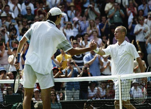 Ivo Karlovic of Croatia shakes hands at the net after beating defending champion Lleyton Hewitt of Australia in 2003