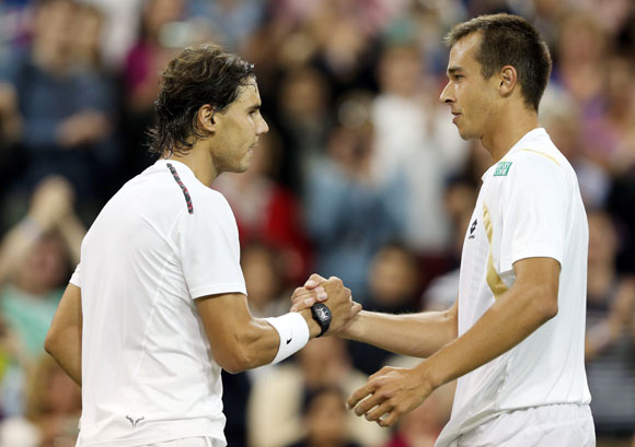 Lukas Rosol of the Czech Republic shakes hands with Rafael Nadal of Spain