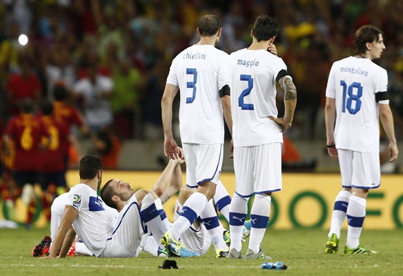 Italy's players react after losing the penalty shoot-out