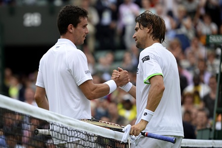 David Ferrer (R) shakes hands with defeated countryman Roberto Bautista
