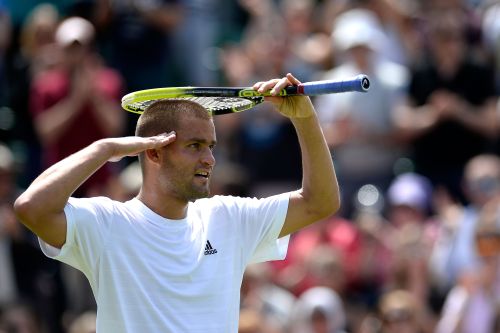 Mikhail Youzhny of Russia celebrates match point during his Gentlemen's Singles third round match against Viktor Troicki of Serbia on day six of the Wimbledon Lawn Tennis Championships