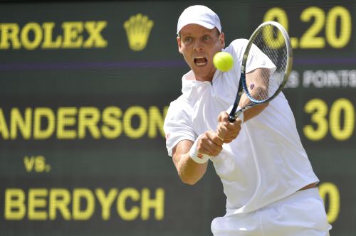 Tomas Berdych of the Czech Republic hits a return to Kevin Anderson of South Africa during their men's singles tennis match at the Wimbledon Tennis Championships