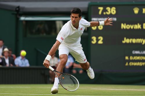 Novak Djokovic of Serbia plays a backhand during the Gentlemen's Singles third round match against Jeremy Chardy of France