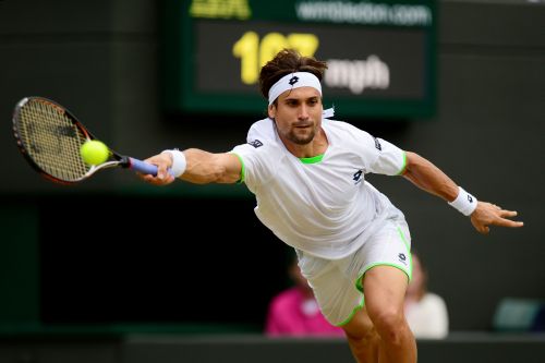 David Ferrer of Spain plays a forehand during the Gentlemen's Singles third round match against Alexandr Dolgopolov of Ukraine on day six of the Wimbledon Lawn Tennis Championships