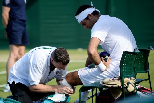 Juan Martin Del Potro of Argentina receives assistance during a break in the Gentlemen's Singles third round match against Grega Zemlja of Slovenia on day six of the Wimbledon Lawn Tennis Championships