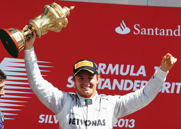 Nico Rosberg of Germany and Mercedes GP celebrates on the podium after winning the British Formula One Grand Prix