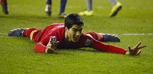 Luis Suarez celebrates after scoring a hat-trick against Wigan on Saturday