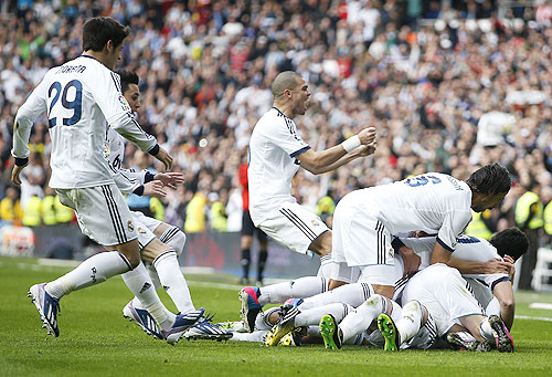 Real Madrid players celebrate after Sergio Ramos scored the winner against Barcelona at the Santiago Bernabeu stadium on Saturday