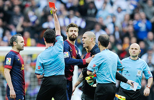 Victor Valdes of FC Barcelona is shown a red card by referee Perez Lasa during their 'Clasico' against Real Madrid on Saturday