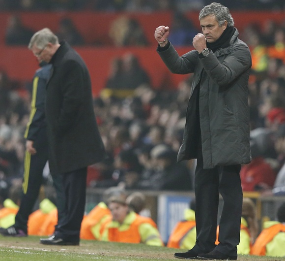Real Madrid's coach Jose Mourinho reacts near Manchester United manager Alex Ferguson (left)