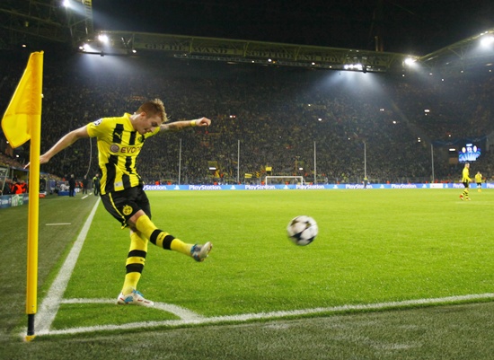 Borussia Dortmund's Marco Reus takes a corner kick
