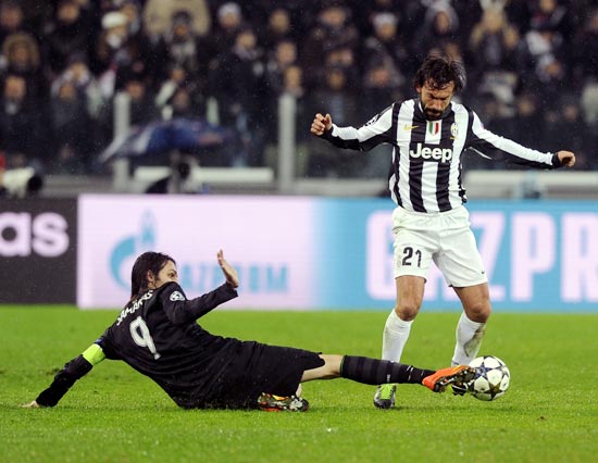 Andrea Pirlo of Juventus duels for the ball with Celtic's Giorgios Samaras