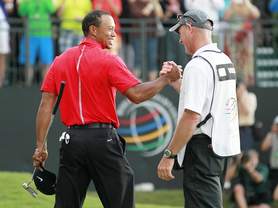 Tiger Woods celebrates with his caddie Joe LaCava