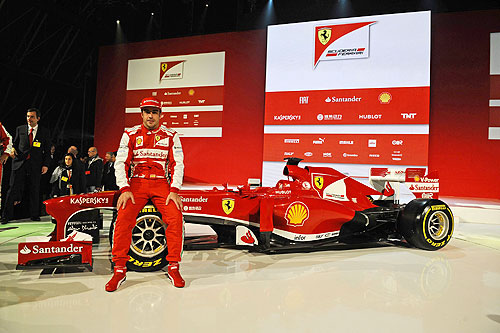 Ferrari Formula One driver Fernando Alonso of Spain poses near the new Ferrari F138 Formula One car