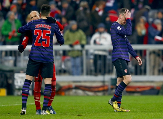 Arsenal's Laurent Koscielny (right) reacts as his teammate Carl Jenkinson bids farewell to Bayern Munich's Arjen Robben