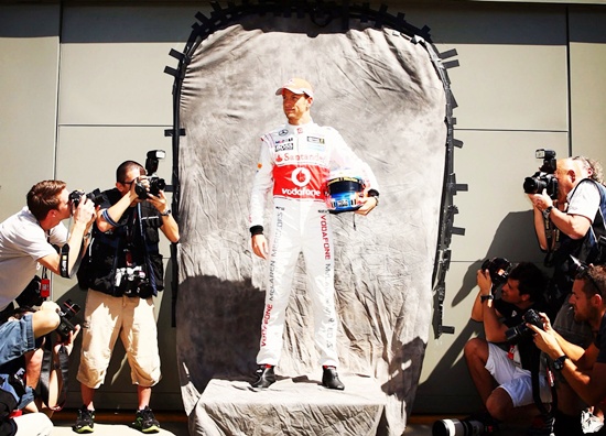 Jenson Button of McLaren poses for photographers