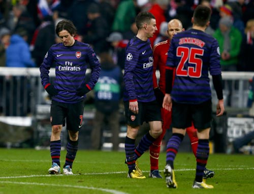 Arsenal's Tomas Rosicky (L) reacts following his team's Champions League round of 16 second leg soccer match against Bayern Munich