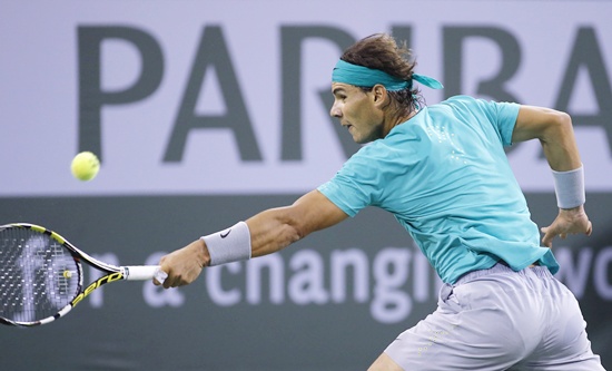 Rafael Nadal of Spain returns a shot