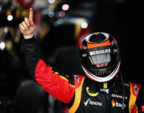Kimi Raikkonen of Finland and Lotus celebrates in parc ferme after winning the Australian Formula One Grand Prix