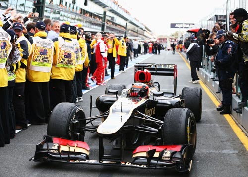 Kimi Raikkonen of Finland and Lotus drives into parc ferme after winning the Australian Formula One Grand Prix