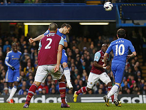 Chelsea's Frank Lampard (centre) heads to score against West Ham during their English Premier League match at Stamford Bridge in London, on Sunday. It was his 200th goal for The Blues