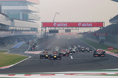 Sebastian Vettel of Germany and Red Bull Racing leads the field into the first corner at the start of the Indian Formula One Grand Prix at Buddh International Circuit on October 28, 2012 in Noida, India