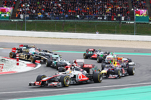 Lewis Hamilton (C) of Great Britain and McLaren takes the lead at the first corner during the start of the German Formula One Grand Prix at the Nurburgring on July 24, 2011 in Nuerburg, Germany