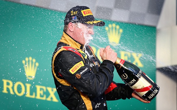 Kimi Raikkonen of Finland and Lotus celebrates on the podium