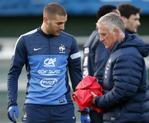 France's coach Didier Deschamps (right) passes by Karim Benzema